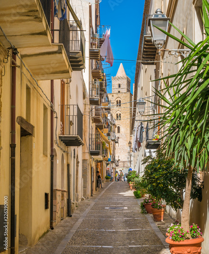 Fototapeta Naklejka Na Ścianę i Meble -  A cozy street in Cefalù on a sunny summer day. Sicily, southern Italy.
