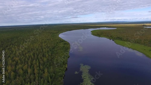 Long Lake in Northern Forest.	Top view of the long lake in Siberia. Around the lake grows a forest