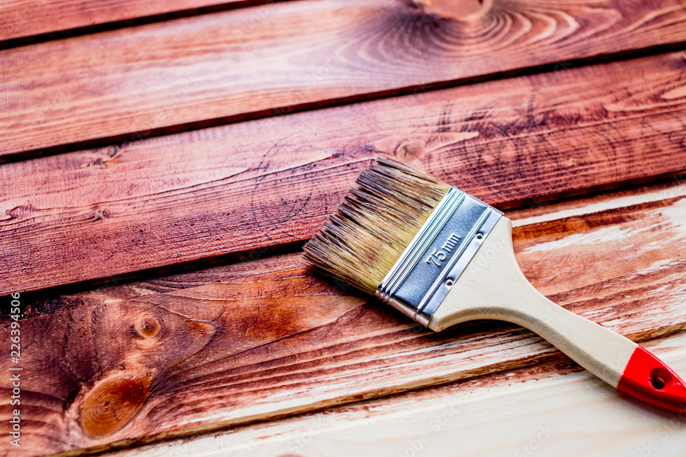 Varnishing a wooden shelf using paintbrush.brush and paint, stain, wooden floor,wall,repair, restoration concept.Paint brush on wooden table use for home decorated. House renovation. Copy space Varnishing a wooden shelf using paintbrush.brush and paint, stain, wooden floor,wall,repair, restoration concept.Paint brush on wooden table use for home decorated. House renovation. Copy space