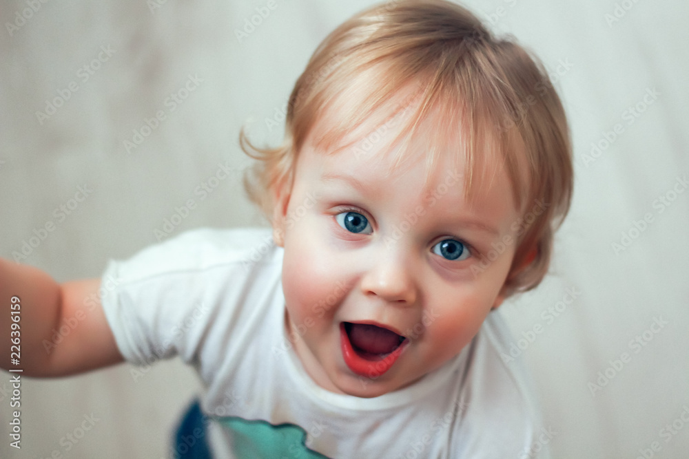 Portrait of a one year old beautiful surprised little boy with blue eyes and blond hair Portrait of a one year old beautiful surprised little boy with blue eyes and blond hair