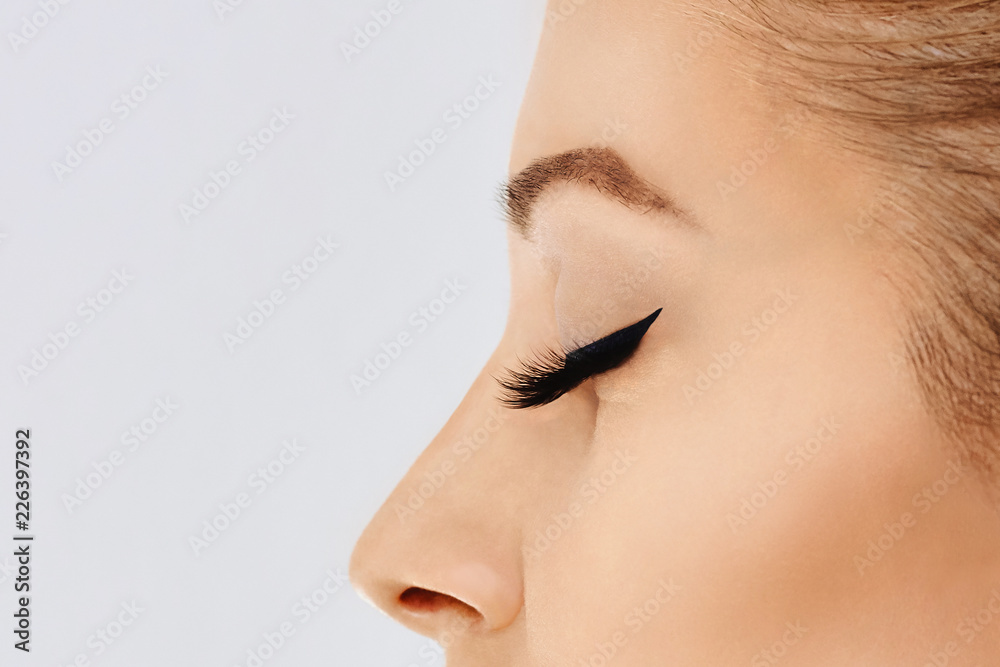 Female eye with extreme long false eyelashes and black liner. Eyelash extensions, make-up, cosmetics, beauty Female eye with extreme long false eyelashes and black liner. Eyelash extensions, make-up, cosmetics, beauty