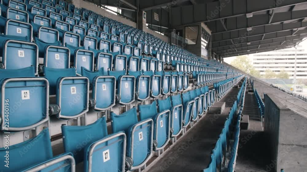 Numbered flip down seats at empty sport stadium