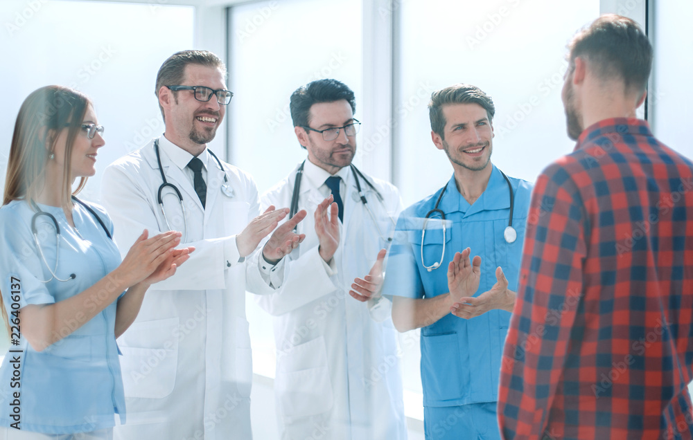 group of doctors congratulating the patient on his recovery group of doctors congratulating the patient on his recovery