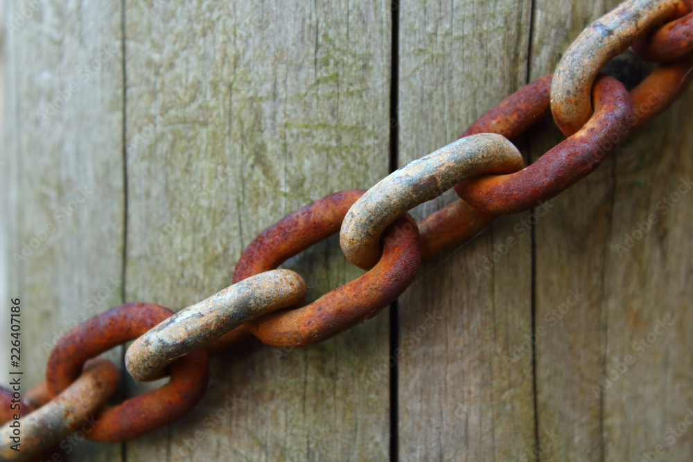 Old rusty chain and log. Close-up. Background. Texture. Old rusty chain and log. Close-up. Background. Texture.