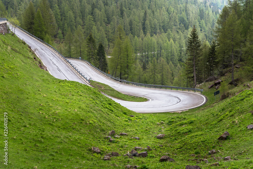 Hairpin Bend along a Mountain Road in the Alps on a Raining Spring Day photo