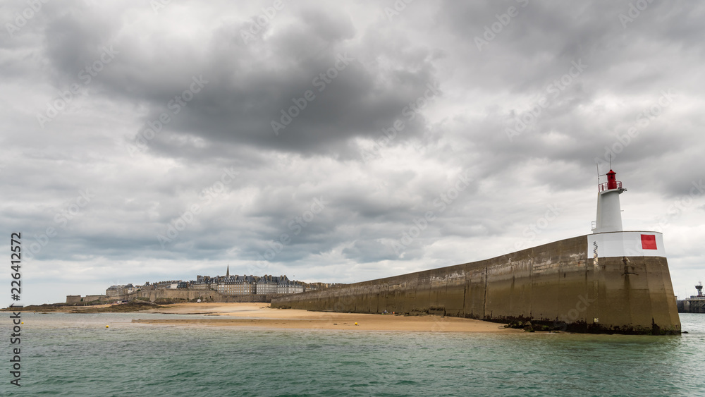 Pier, lighthouse an city of Saint Malo on a cloudy day in summer