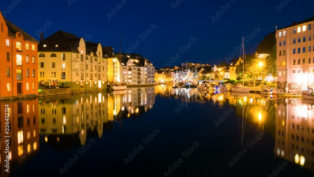 Alesund, Norway. View of center of Alesund, Norway at night. Time-lapse with reflection in the river and historical buildings at sunset. Illuminated atchitecture, zoom in Alesund, Norway. View of center of Alesund, Norway at night. Time-lapse with reflection in the river and historical buildings at sunset. Illuminated atchitecture, zoom in