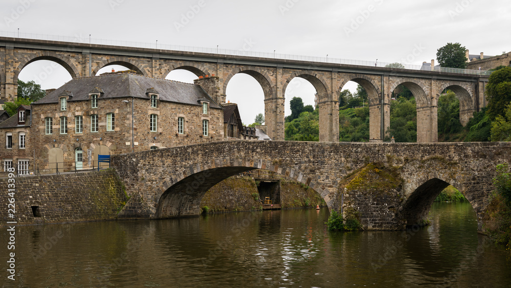 Old stone bridges in Dinan on a cloudy day in summer