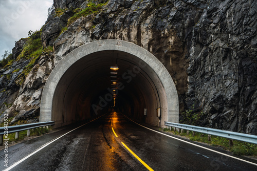Asphalt road leading to tunnel photo