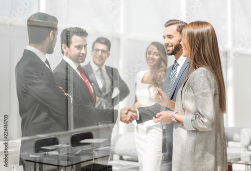 employees discuss business documents standing in the office