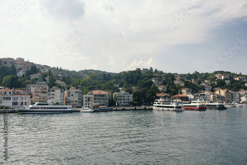 View of big motorboats, yachts, buildings on European side and Bosphorus in Istanbul.