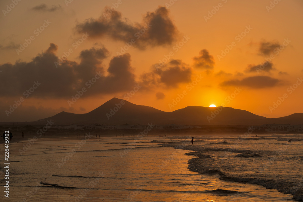 sunset over the ocean beach in orange tones