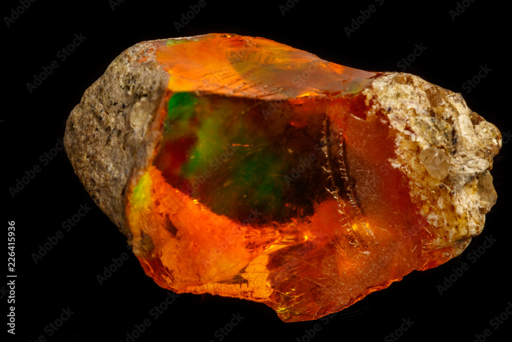 Macro Opal mineral stone in rock on black background Macro Opal mineral stone in rock on black background
