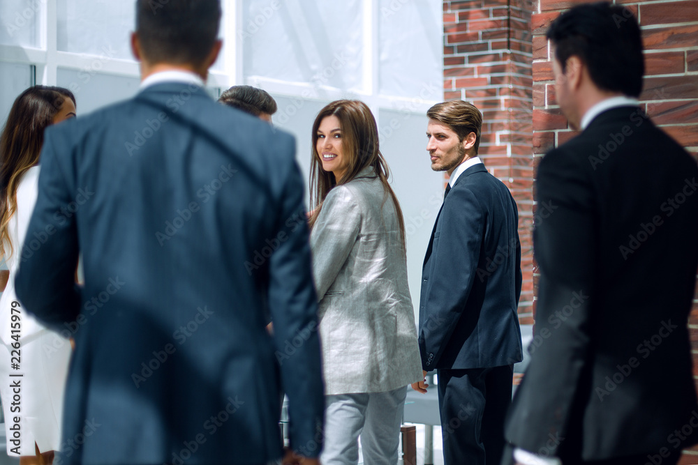group of business people talking, standing in the lobby of the business center. group of business people talking, standing in the lobby of the business center.