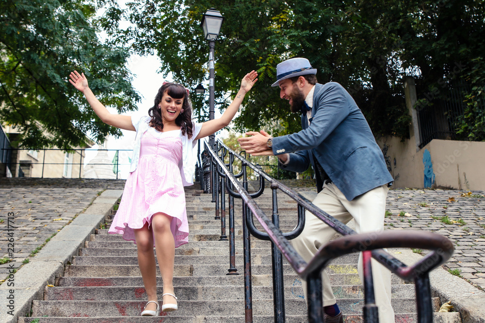 Couple playing in the stairs of Montmartre in Paris