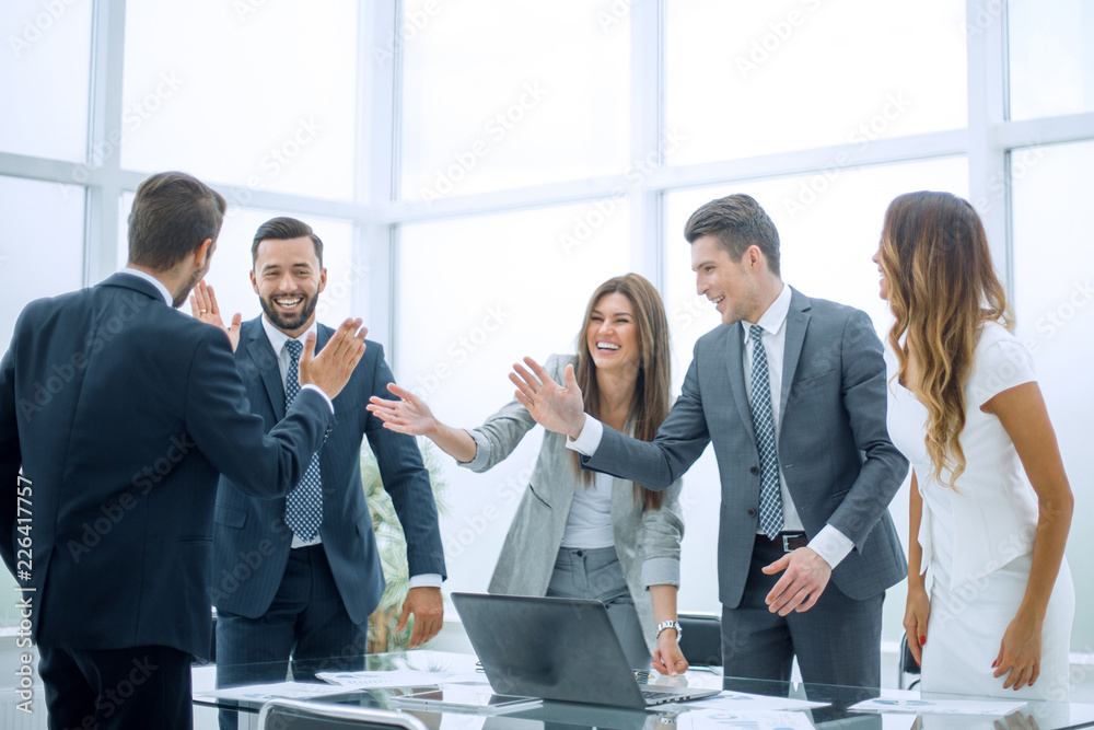 happy business team standing near office Desk happy business team standing near office Desk