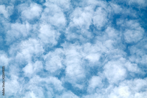 Abstract background with blue sky and small white clouds. Mackerel sky with altocumulus cloud