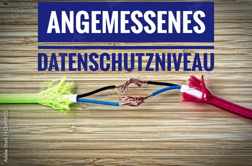 Colorful cables were separated and makeshift mended with inscription in German Angemessenes Datenschutzniveau in english Reasonable level of data protection photo