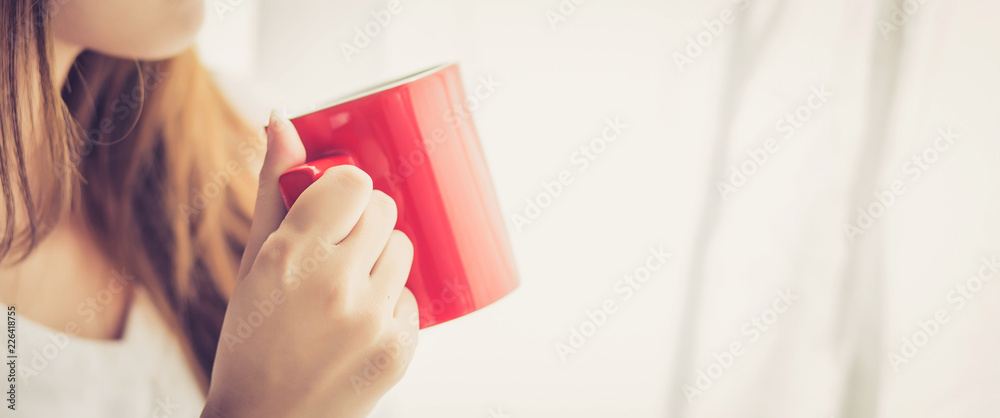 Banner website beautiful young asian woman with drink acup of coffee standing curtain window background in bedroom, girl relax in morning at home, lifestyle concept. Banner website beautiful young asian woman with drink acup of coffee standing curtain window background in bedroom, girl relax in morning at home, lifestyle concept.