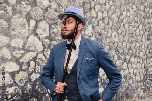 Funny man with walking stick in vintage suit