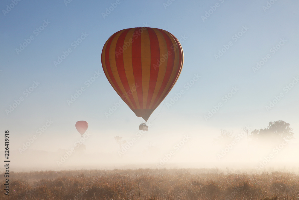 Fototapeta premium Hot Air Balloon flight over Gold Coast Hinterland, Queensland, Australia at sunrise in mid winter