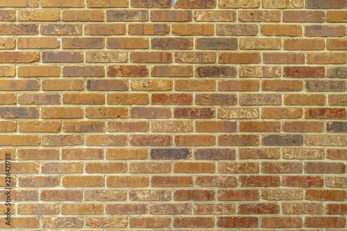 yellow orange solid brick wall with cement grouting