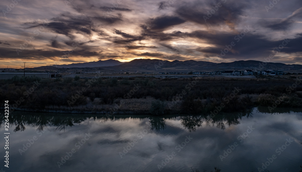 Panorama sunset with clouds reflecting off the river