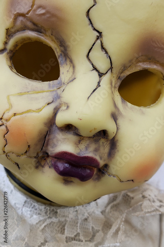 Fototapeta Naklejka Na Ścianę i Meble -  Scary cracked old doll face for halloween