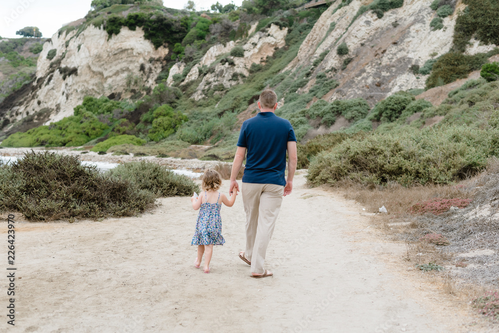 Dad and Daughter walking down a path