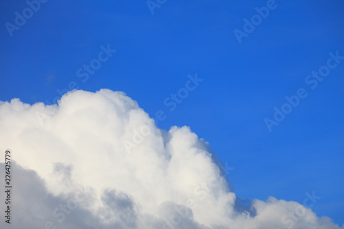 Bright blue sky with white fluffy beautiful cloud formation on sunny day for design background and wallpaper