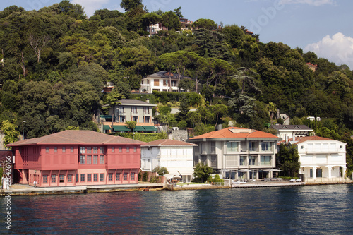 View of historical, old Turkish / Ottoman houses by Bosphorus on Asian side of Istanbul. It is a sunny summer day.