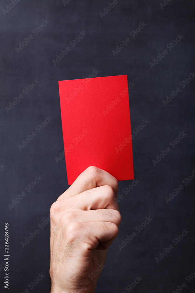 Hand holding red card Hand holding red card