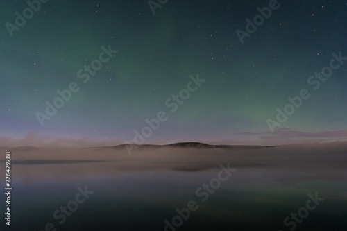 Faint northern lights above the lake