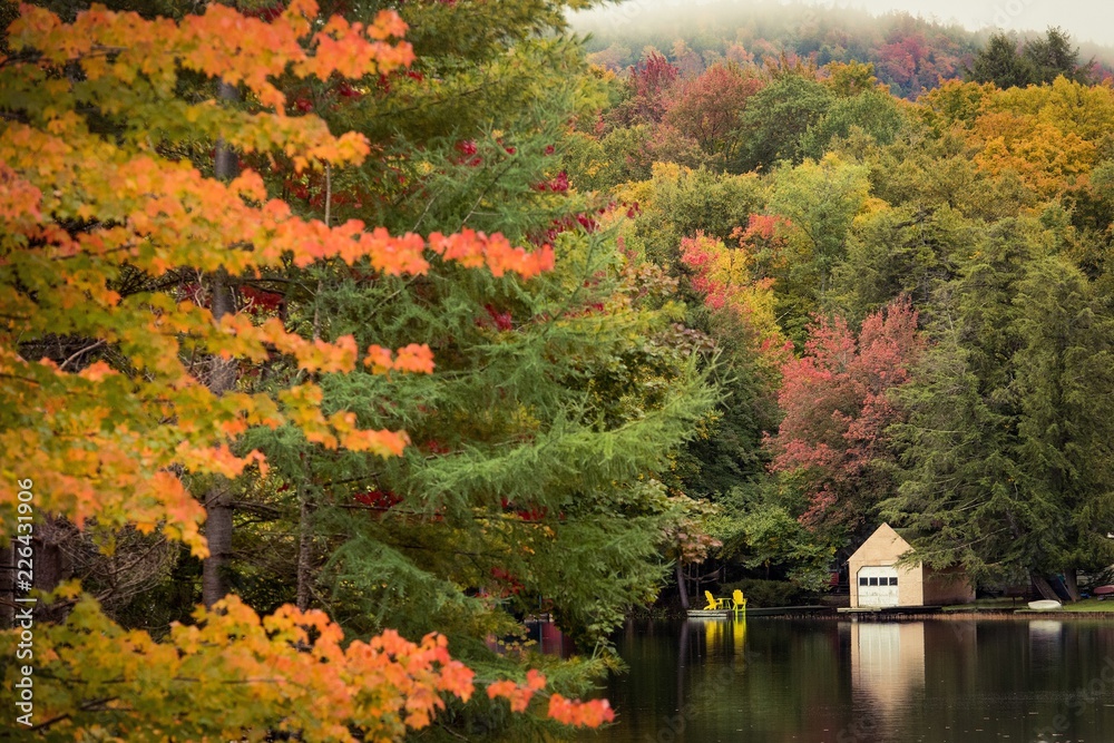 Adirondack chairs and fall color reflection in New England