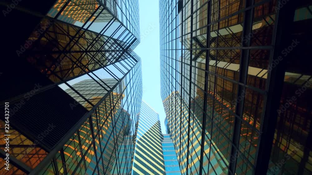 modern skyscrapers in business district against blue sky. Futuristic modern architecture building. Financial economy growth concept.