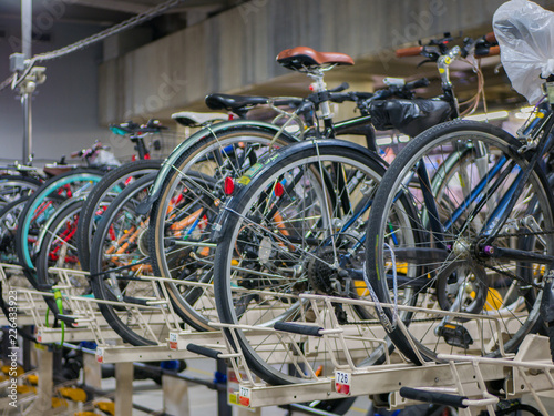 Tokyo, Japan - September 11, 2018. Two rows system of bicycles parking indoor garage near the Shinjuku train station. They be designed for less spaces, more useful concept.