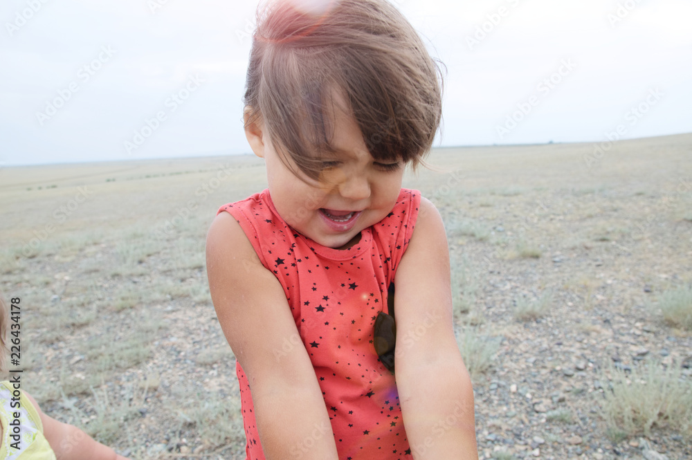 Little girl happy smiling in big landscape environment. Child emotionally with expression playing outdoor