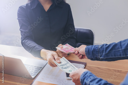 Exchange money, Business peoople exchange American dollars for Yuan RMB (Chinese money)
