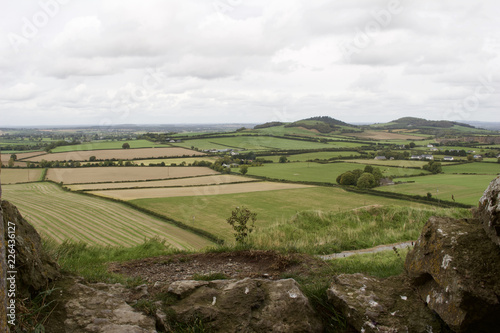 View of an Irish agricultural countryside with ancient stone ruins in the foreground
