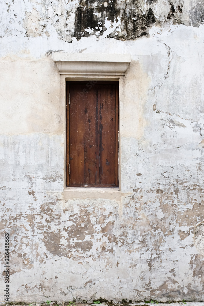 Weathered white wall background with chinese styled wooden window Weathered white wall background with chinese styled wooden window