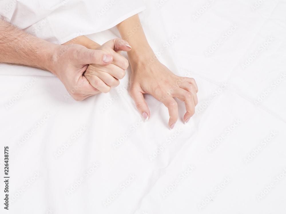 Four hands on the linens. Couple having sex on the bed. Four hands on the linens. Couple having sex on the bed.