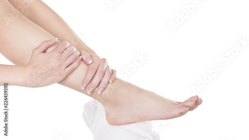 woman applying moisturizing cream on her feet. Skin care concept.