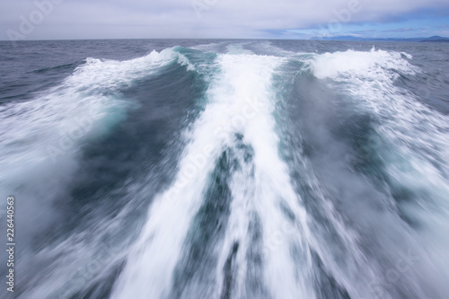 Motion blurred waves left by the deep sea boat in the Pacific ocean.