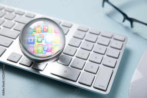 business icon in crystal ball on white computer keyboard