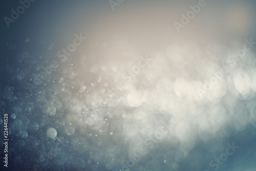 Blurred abstract bokeh light of fly water background, Christmas two tone colors.