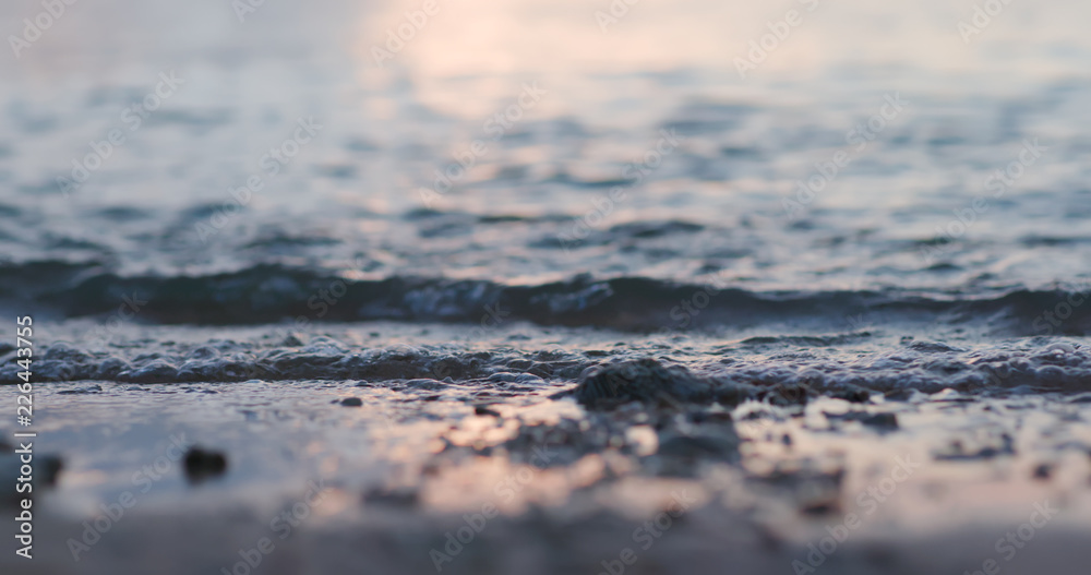 Sea waves over sand beach at sunset time Sea waves over sand beach at sunset time