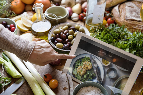 Woman reading healthy foods recipe on a tablet photo