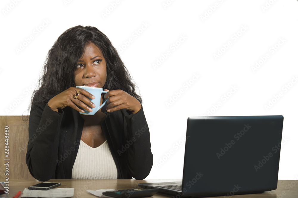 young happy and attractive black afro American business woman working at office computer desk smiling drinking cup of coffee relaxed and thoughtful young happy and attractive black afro American business woman working at office computer desk smiling drinking cup of coffee relaxed and thoughtful