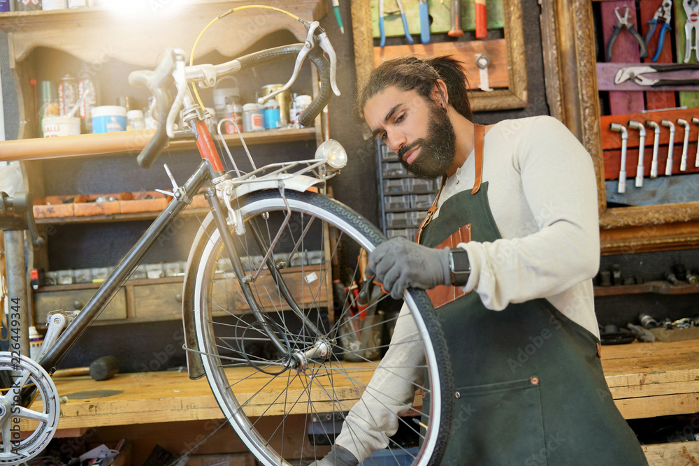 Man working in cycle repair shop
