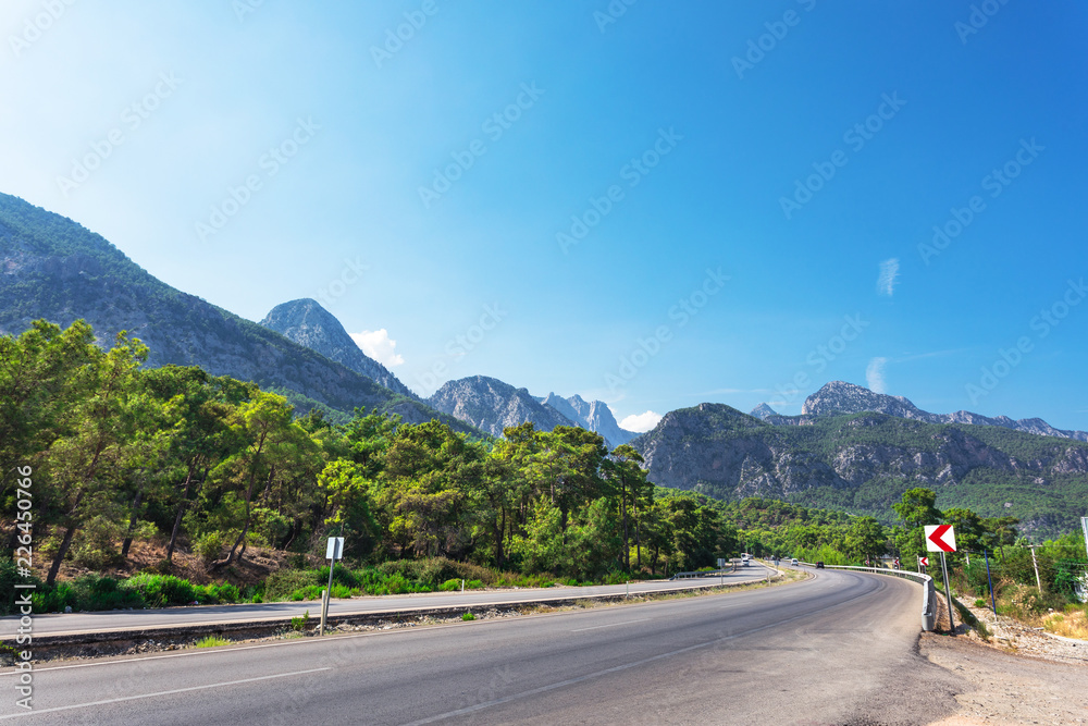 Scenic busy freeway, wagging between the mountain ranges on the coast of the sea Scenic busy freeway, wagging between the mountain ranges on the coast of the sea